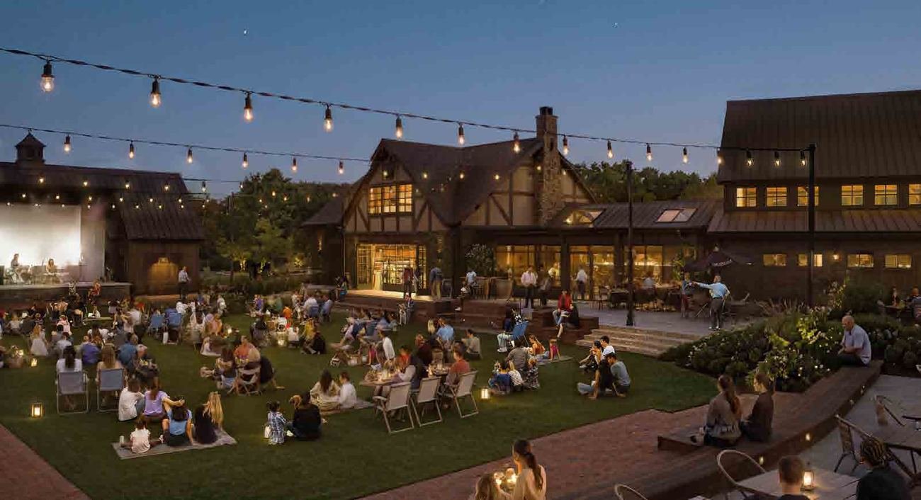 String lights over a lawn at The Village at Tuxedo Reserve in the evening