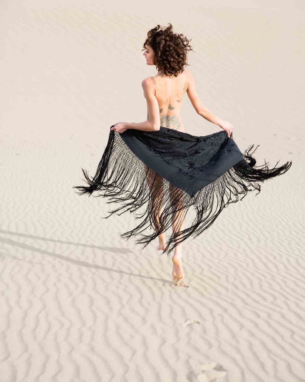 A dancer on white sand, photograph by Adam Pass
